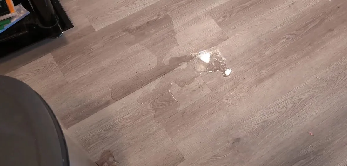 Single drop of water on a wood-look laminate floor