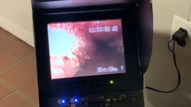Sewer camera monitor showing the inside of a pipe with a distance readout in the corner